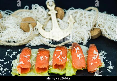 smoked norwegian Salmon in front of a fishing net Stock Photo