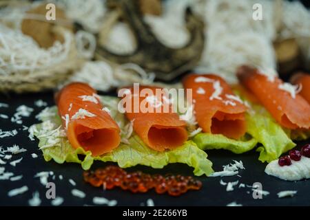 smoked norwegian Salmon in front of a fishing net Stock Photo