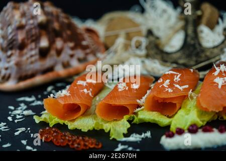 smoked norwegian Salmon in front of a fishing net Stock Photo