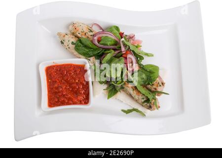 Chicken kebab with spicy tomato sauce on skewers. Isolated in a white background. Close-up. Stock Photo