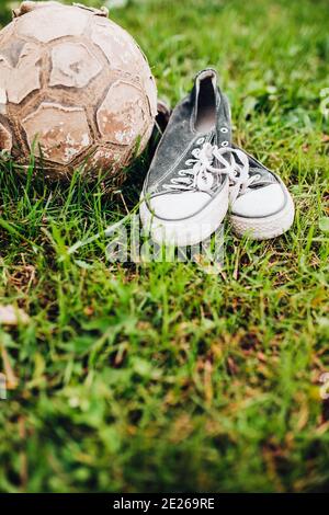 Old vintage worn out sports equipment for playing soccer - childhood is over and games are over Stock Photo