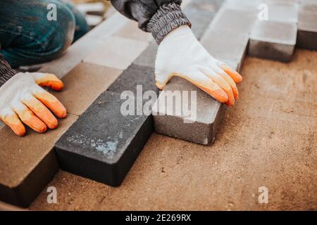 Bonding granite tiles to concrete subfloors outside the house - porch and patio cladding Stock Photo