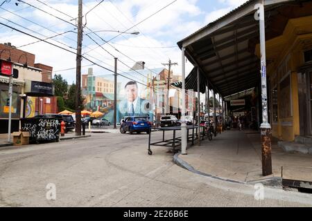 Covered sidewalk on a street in south Philadelphia, USA. A mural of former city mayor and police commissioner Frank Rizzo is on a nearby building. Stock Photo