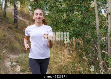 Young woman jogging in the park Stock Photo