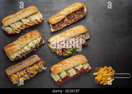 Set of various assorted roasted panini sandwiches over stone background Stock Photo