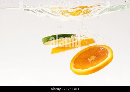 Slices floating in water on white background Stock Photo