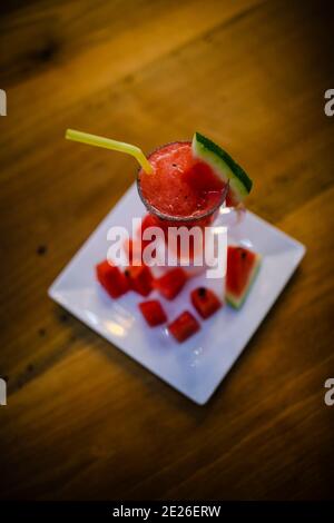 watermelon smoothie in glass. watermelon juice on the wood table peak angle. Stock Photo