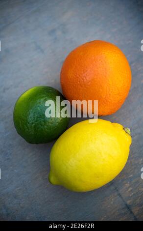 Still life of three citrus fruits, an orange, a lime and a lemon Stock Photo