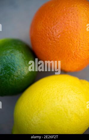Still life of three citrus fruits, an orange, a lime and a lemon Stock Photo