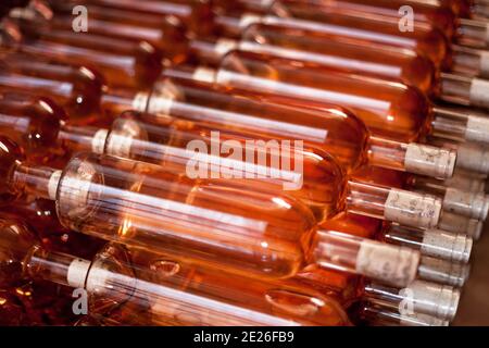 Selective focus shot of a heap of bottles of rose wine Stock Photo