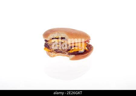 McDonalds Triple Cheeseburger with bite taken out on white background Stock Photo