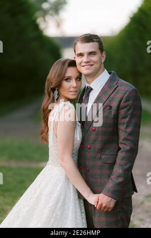 The portrait of stunning bride and smiling groom. Happy newlyweds. Wedding couple. Wedding photo Stock Photo