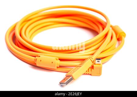 Orange rolled cable isolated on white background. Stock Photo