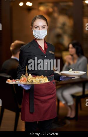 Waitress serving plates in a coffee shop Stock Photo - Alamy