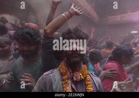 Devotees celebrating Holi at the Banke Bihari temple. At this celebration the  participants throw colored powder at each other. Stock Photo