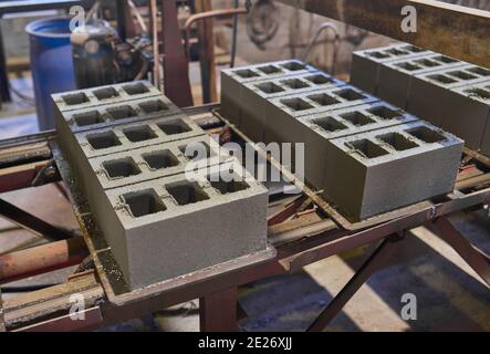 Cinder blocks lie on the ground and dried. on cinder block production plant Stock Photo