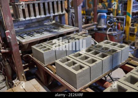 Cinder blocks lie on the ground and dried. on cinder block production plant Stock Photo