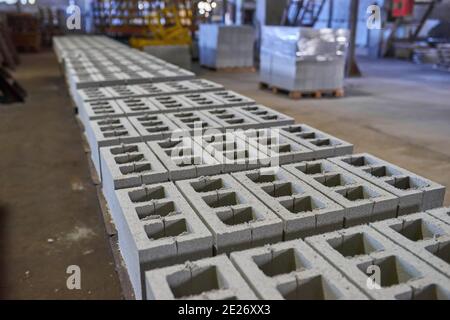 Cinder blocks lie on the ground and dried. on cinder block production plant Stock Photo