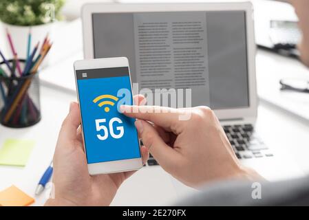 5G technology, high speed communication, data transmission. Hand holding smartphone Stock Photo