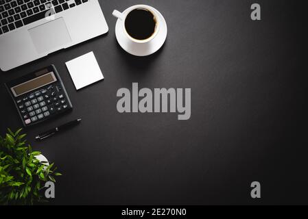 Workspace with laptop, office supplies. Stylish table desk, image with copy space on black background Stock Photo