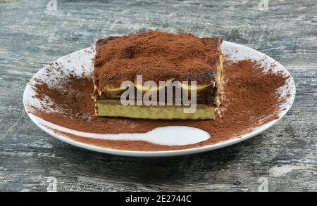 Piece of Italian dessert , tiramisu on wooden table Stock Photo