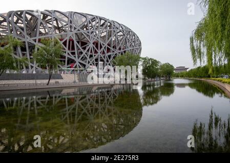 Birds nest stadium at the Olympic park reflected on the river at Beijing, China. Stock Photo