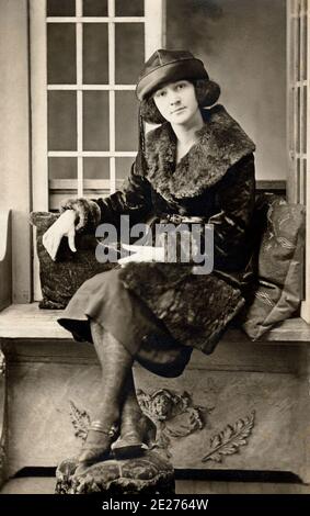 Stylish young woman in fur coat and leather hat circa 1910. Stock Photo