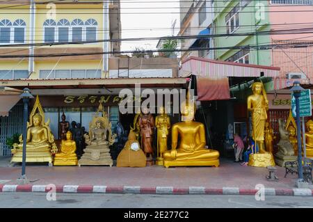 Bangkok, Thailand, December, 2015: Golden Buddha statue store. Variety of different big Buddha statues in a shop along the road. Stock Photo