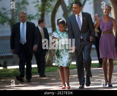 President Barack Obama (C) walks with his daughters Sasha (L) and Malia (R) through Lafayette Square from the White House to St. John's Protestant Episcopal Church in Washington, DC., on July 17, 2011. The First Family attended Sunday services. Photo by Brendan Smialowski/Bloomberg News/ABACAPRESS.COM Stock Photo