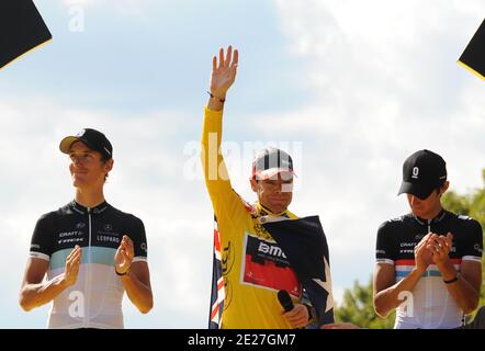 Andy Schleck (L) of team Leopard congratulates his teammate and brother Frank Schleck (R) as Cadel Evans (C) of team BMC celebrates on the podium after the 21st and final stage of the 98th Le Tour de France cycling race between Creteil and Paris, on the Champs Elysees, in Paris, France on July 24, 2011. Photo by Giancarlo Gorassini/ABACAPRESS.COM Stock Photo