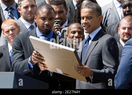 12 August 2011 Ã Washington, D.C. Ã Green Bay Packers Player Charles  Woodson presents an ownership share to President Barack Obama during an  event to honor the Super Bowl XLV champions at