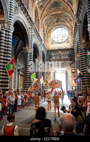 Historical parade inside Siena Cathedral (Duomo di Siena) before Siena Palio race, Siena, Tuscany, Italy Stock Photo