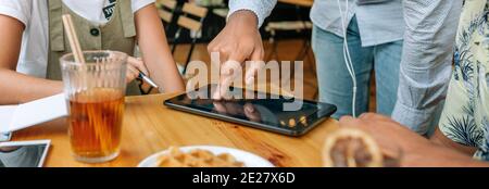 Unrecognizable friends using tablet in a coffee shop Stock Photo