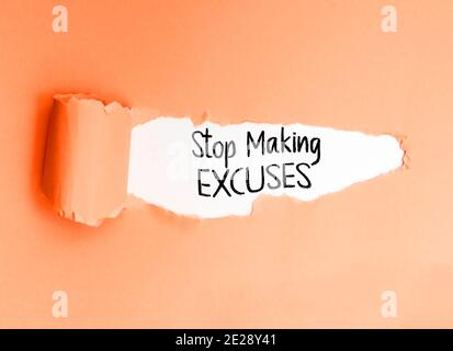 Motivational phrase Stop Making Excuses, written on a torn paper, encouraging action. Stock Photo