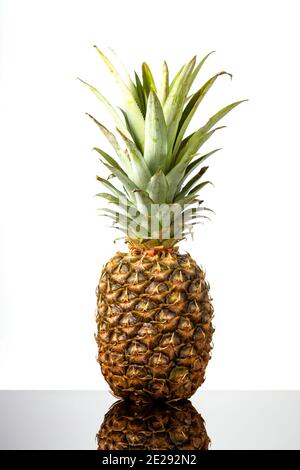 Ripe, Fresh Fruit pineapple on black glass table on white background Stock Photo