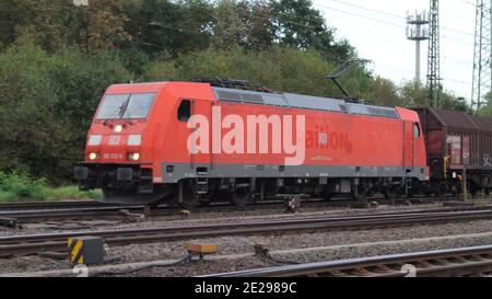 A Deutsche Bahn (DB) Class 185 electric locomotive with mixed manifest goods wagons at Cologne-Gremberg rail classification yard, Germany, Europe. Stock Photo