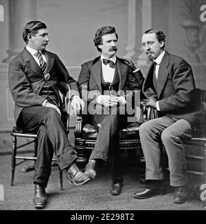 Group photo portrait of author and humorist Mark Twain (a.k.a. Samuel L. Clemens; middle), noted American Civil War correspondent and author George Alfred Townsend (left), and David Gray, editor of the Buffalo Courier (right), February 1871 Stock Photo