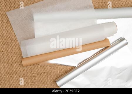 https://l450v.alamy.com/450v/2e29be2/different-type-of-paper-for-baking-needs-parchment-paper-foil-wax-paper-close-up-on-rustic-background-flat-lay-2e29be2.jpg