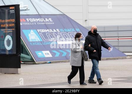 (210113) -- LONDON, Jan. 13, 2021 (Xinhua) -- People wearing face masks walk out of the Vaccination Centre at ExCel exhibition centre after receiving the vaccination in London, Britain, Jan. 12, 2021. British Prime Minister Boris Johnson on Monday warned against 'false complacency' as the country is seeking to speed up the coronavirus vaccine rollout. According to the prime minister, 2.4 million coronavirus jabs have been administered across Britain. Seven new mass vaccination sites in England opened Monday, as the country races against time to bring the pandemic under control. (Xinhua/ Stock Photo