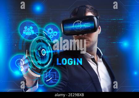 Business, Technology, Internet and network concept. Young businessman working in virtual reality glasses sees the inscription: Login Stock Photo