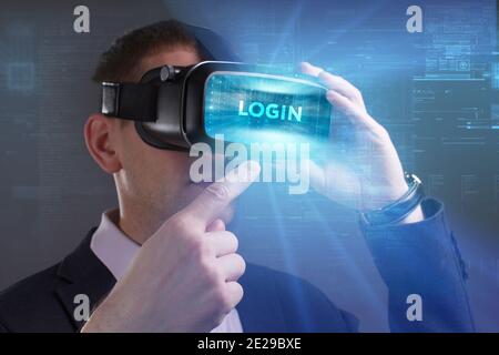Business, Technology, Internet and network concept. Young businessman working in virtual reality glasses sees the inscription: Login Stock Photo