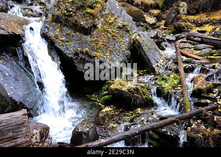 A stormy mountain stream flowing downward bending around stone boulders. Boki river, Altai, Siberia, Russia. Stock Photo