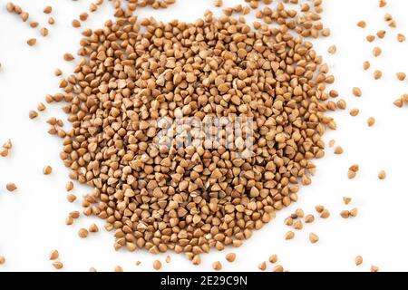 Buckwheat grains. Pile of buckwheat isolated on white background. Top view. The concept of diet and healthy eating, the background texture of the Stock Photo