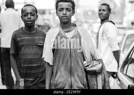 ADDIS ABABA, ETHIOPIA - Jan 05, 2021: Addis Ababa, Ethiopia, January 27, 2014, Children working as shoe shine boys on the street, looking straight at Stock Photo