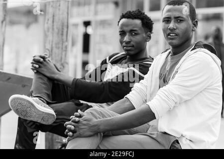 ADDIS ABABA, ETHIOPIA - Jan 05, 2021: Addis Ababa, Ethiopia, January 27, 2014, Two young men relaxing on the street corner Stock Photo