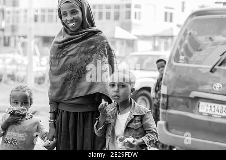 ADDIS ABABA, ETHIOPIA - Jan 05, 2021: Addis Ababa, Addis Ababa, Ethiopia, January 27, 2014, Mother and two children holding hands on a quiet city stre Stock Photo