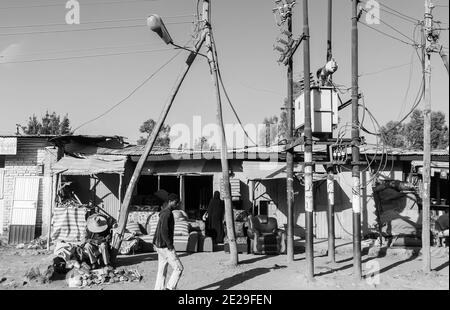 ADDIS ABABA, ETHIOPIA - Jan 05, 2021: Addis Ababa, Ethiopia, January 30, 2014, Small shops on a dirt road with a few informal traders nearby Stock Photo