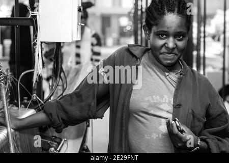 ADDIS ABABA, ETHIOPIA - Jan 05, 2021: Addis Ababa, Ethiopia - January 30, 2014: Young female worker Inside a Fabric Weaving Factory Stock Photo