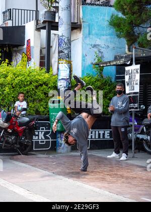 MEDELLIN, COLOMBIA - Jan 05, 2021: Medellin, Antioquia, Colombia - December 23 2020: Young Man Break Dance in Black and Grey Outfits in the Comuna 13 Stock Photo