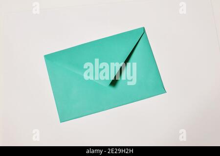 Top table of an closed green envelope on white background Stock Photo